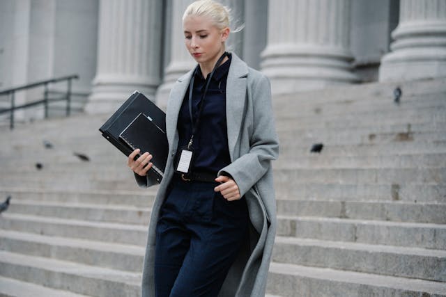serious-businesswoman-hurrying-with-documents-from-courthouse