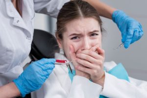 An anxious child with dental equipment 